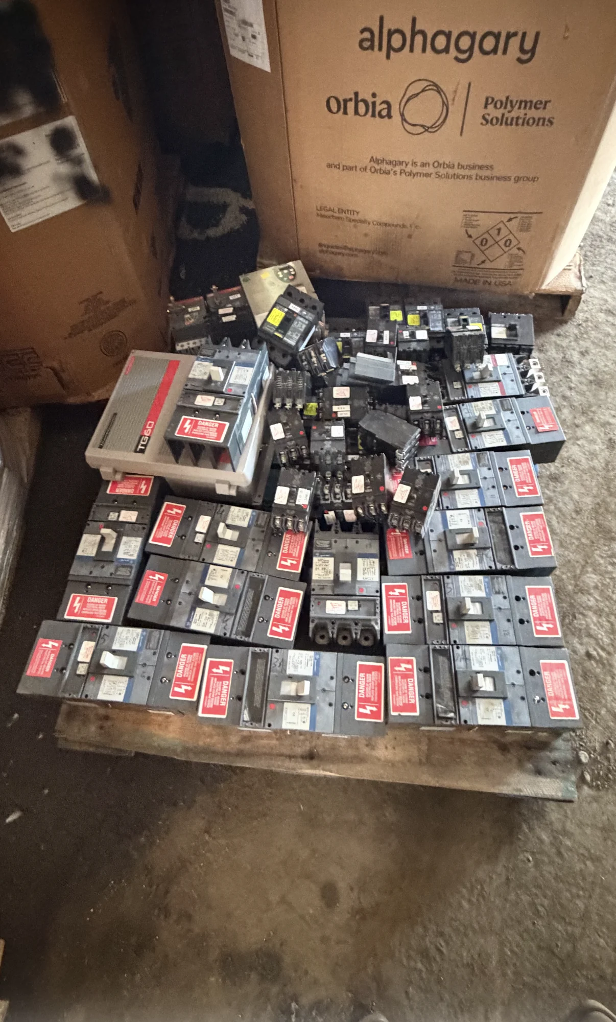 Owner-supplied pallet containing assorted used circuit breakers and electrical components