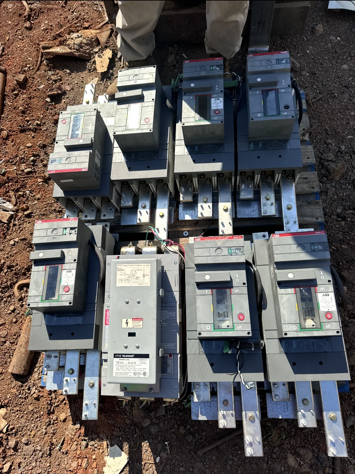 Owner-supplied outdoor lot containing large ABB and other industrial circuit breakers